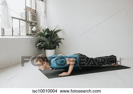 Man doing half plank in yoga studio View Large Photo Image Picture - Man doing half plank in yoga studio. Fotosearch