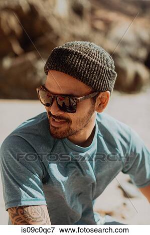 Stock Photo - Man enjoying beach on sunny day, Big Sur, California, United States. Fotosearch