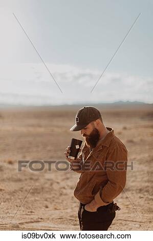 Man enjoying cup of tea in desert, Trona Pinnacles, California, US View Large Photo Image Stock Image - Man enjoying cup of tea in desert, Trona Pinnacles, California, US. Fotosearch