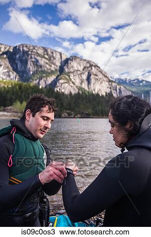Man helping woman with wetsuit, Squamish, Canada View Large Photo Image Stock Image - Man helping woman with wetsuit, Squamish, Canada. Fotosearch