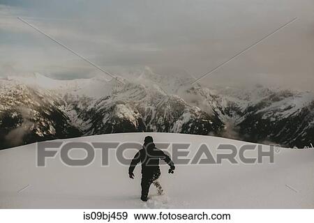 Stock Photo - Man in deep snow on mountain, Abbotsford, Canada. Fotosearch