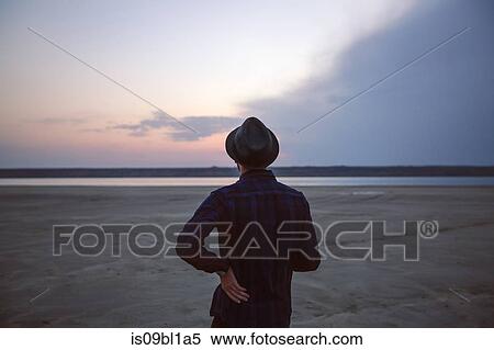 Man in hat on beach at sunset, Odessa, Ukraine View Large Photo Image Stock Photography - Man in hat on beach at sunset, Odessa, Ukraine. Fotosearch