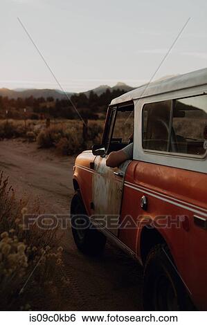 Man in off road vehicle on landscape of Kennedy Meadows, California, US View Large Photo Image Stock Photograph - Man in off road vehicle on landscape of Kennedy Meadows, California, US. Fotosearch