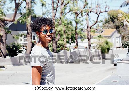 Stock Photo - Man in sunny residential street, Long Beach, California, US. Fotosearch