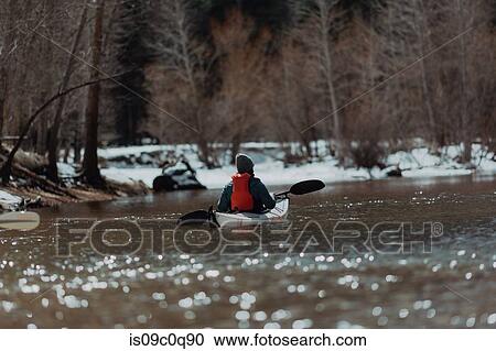 Stock Image - Man kayaking in lake, Yosemite Village, California, United States. Fotosearch