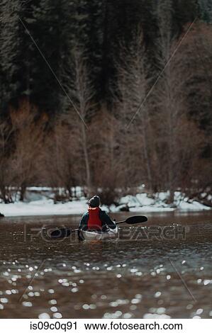 Stock Image - Man kayaking in lake, Yosemite Village, California, United States. Fotosearch