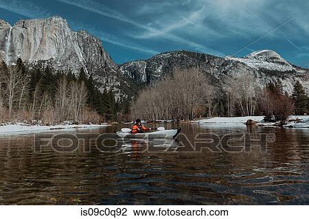 Stock Image - Man kayaking in lake, Yosemite Village, California, United States. Fotosearch
