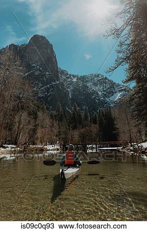 Man kayaking in lake, Yosemite Village, California, United States View Large Photo Image Stock Image - Man kayaking in lake, Yosemite Village, California, United States. Fotosearch
