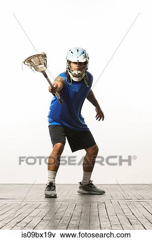 Man modelling lacrosse helmet and stick View Large Photo Image Stock Photo - Man modelling lacrosse helmet and stick. Fotosearch