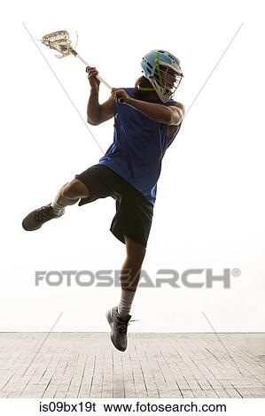 Man modelling lacrosse helmet and stick View Large Photo Image Stock Photograph - Man modelling lacrosse helmet and stick. Fotosearch