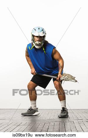 Man modelling lacrosse helmet and stick View Large Photo Image Stock Photograph - Man modelling lacrosse helmet and stick. Fotosearch
