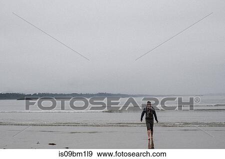 Man on beach, Tofino, Canada View Large Photo Image Stock Photo - Man on beach, Tofino, Canada. Fotosearch