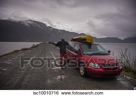 Stock Photograph - Man on canoe trip in Squamish River, Howe Sound, Canada. Fotosearch
