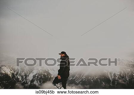 Stock Image - Man on snow covered mountain, Abbotsford, Canada. Fotosearch