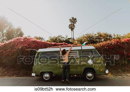 Man on van road trip loading surfboard, Ventura, California, US View Large Photo Image Stock Image - Man on van road trip loading surfboard, Ventura, California, US. Fotosearch
