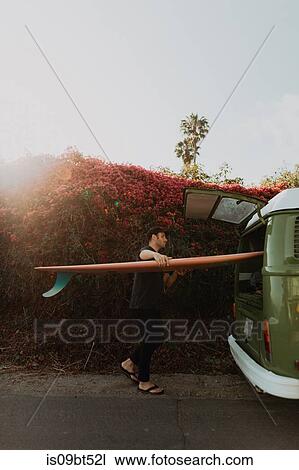 Man on van road trip loading surfboard, Ventura, California, US View Large Photo Image Stock Image - Man on van road trip loading surfboard, Ventura, California, US. Fotosearch