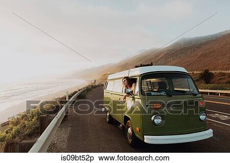 Man on van road trip on coastal road, Ventura, California, US View Large Photo Image Stock Photography - Man on van road trip on coastal road, Ventura, California, US. Fotosearch