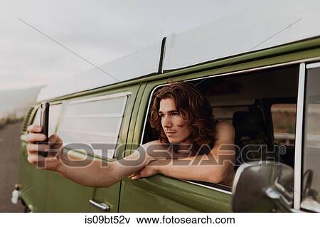 Man on van road trip taking selfie, Ventura, California, US View Large Photo Image Stock Photo - Man on van road trip taking selfie, Ventura, California, US. Fotosearch