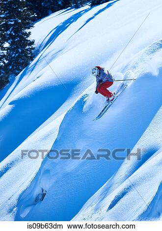 Picture - Man skiing down steep mountainside, Aspen, Colorado, USA. Fotosearch