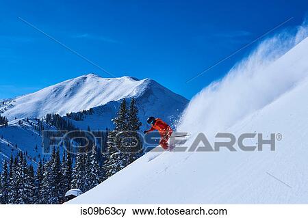Man skiing down steep snow covered mountainside, Aspen, Colorado, USA View Large Photo Image Stock Photo - Man skiing down steep snow covered mountainside, Aspen, Colorado, USA. Fotosearch