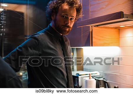Man standing in kitchen View Large Photo Image Stock Photo - Man standing in kitchen. Fotosearch