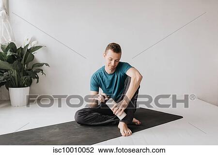 Man taking break in yoga studio View Large Photo Image Stock Image - Man taking break in yoga studio. Fotosearch
