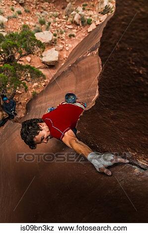 Stock Photo - Man trad climbing, Indian Creek, Moab, Utah, USA. Fotosearch