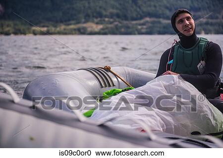 Man travelling on inflatable boat, Squamish, Canada View Large Photo Image Stock Image - Man travelling on inflatable boat, Squamish, Canada. Fotosearch