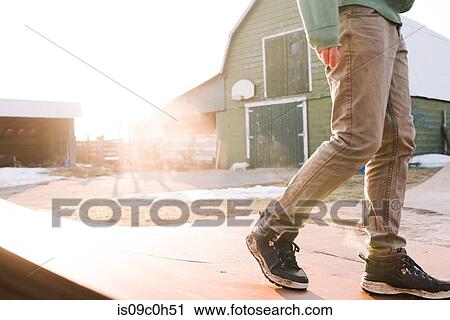 Man walking across farmyard skateboard ramp, waist down View Large Photo Image Stock Image - Man walking across farmyard skateboard ramp, waist down. Fotosearch