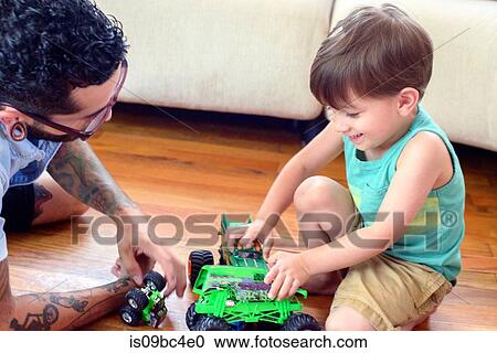 Man watching son play with toys View Large Photo Image Stock Image - Man watching son play with toys. Fotosearch