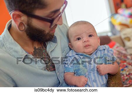 Stock Photo - Man with baby boy in arms. Fotosearch
