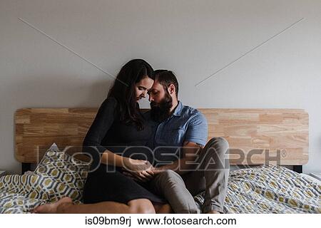Man with hand on pregnant wife's belly View Large Photo Image Stock Image - Man with hand on pregnant wife's belly. Fotosearch