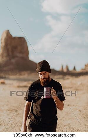 Man with mug of tea in desert, Trona Pinnacles, California, US View Large Photo Image Stock Image - Man with mug of tea in desert, Trona Pinnacles, California, US. Fotosearch
