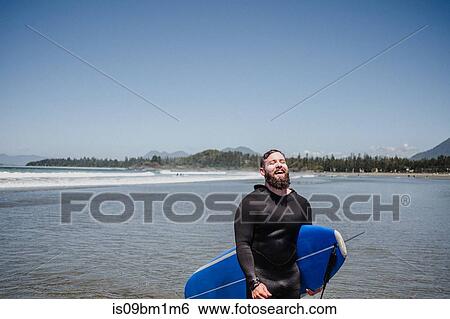 Man with surfboard on beach, Tofino, Canada View Large Photo Image Stock Photograph - Man with surfboard on beach, Tofino, Canada. Fotosearch