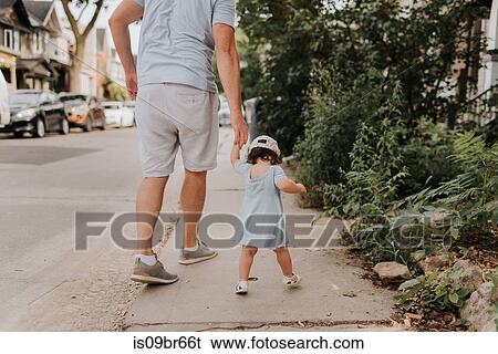 Man with toddler daughter on street View Large Photo Image Stock Photograph - Man with toddler daughter on street. Fotosearch