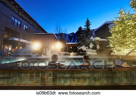 Mature couple relaxing in outdoor hotel hot tub at dusk, Aspen, Colorado, USA View Large Photo Image Stock Photograph - Mature couple relaxing in outdoor hotel hot tub at dusk, Aspen, Colorado, USA. Fotosearch