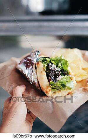 Meal of salad wrap and potato chips View Large Photo Image Picture - Meal of salad wrap and potato chips. Fotosearch
