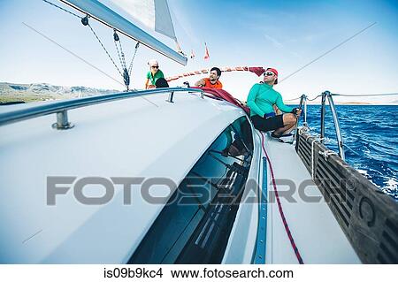 Picture - Men and woman yachting near coast, Croatia. Fotosearch