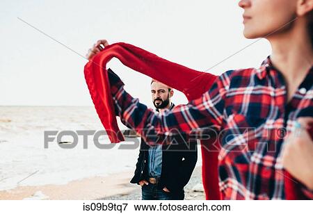 Stock Photo - Mid adult man and girlfriend on beach, Odessa Oblast, Ukraine. Fotosearch
