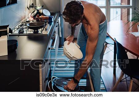 Mid adult man preparing meal removing colander from drawer View Large Photo Image Stock Photo - Mid adult man preparing meal removing colander from drawer. Fotosearch