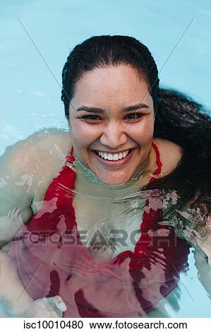 Mid adult woman with wet hair in outdoor swimming pool, portrait, Cape Town, South Africa View Large Photo Image Stock Image - Mid adult woman with wet hair in outdoor swimming pool, portrait, Cape Town, South Africa. Fotosearch