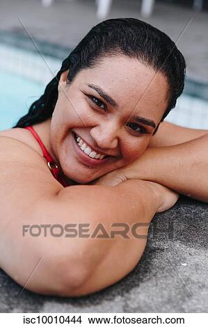 Mid adult woman with wet hair leaning on outdoor swimming poolside, head and shoulder portrait, Cape Town, South Africa View Large Photo Image Picture - Mid adult woman with wet hair leaning on outdoor swimming poolside, head and shoulder portrait, Cape Town, South Africa. Fotosearch