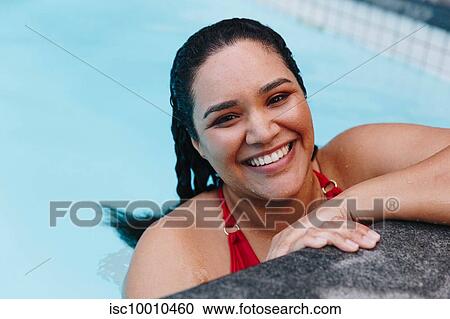 Mid adult woman with wet hair resting on outdoor swimming poolside, head and shoulder portrait, Cape Town, South Africa View Large Photo Image Stock Image - Mid adult woman with wet hair resting on outdoor swimming poolside, head and shoulder portrait, Cape Town, South Africa. Fotosearch