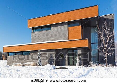 Modern grey brick and stained wood finish cube style house facade in winter View Large Photo Image Stock Photo - Modern grey brick and stained wood finish cube style house facade in winter. Fotosearch