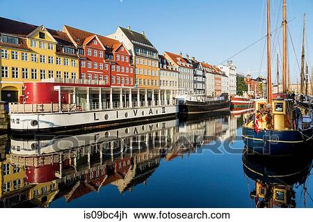 Moored boats and colourful 17th century town houses on Nyhavn canal, Copenhagen, Denmark View Large Photo Image Stock Image - Moored boats and colourful 17th century town houses on Nyhavn canal, Copenhagen, Denmark. Fotosearch