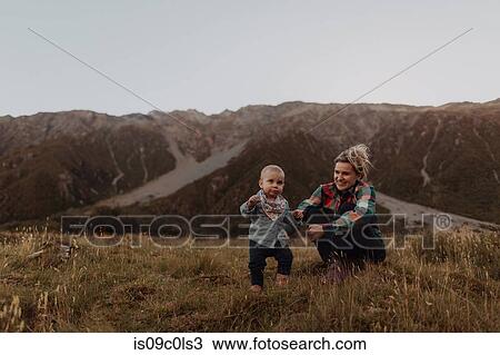 Stock Image - Mother and baby exploring wilderness, Wanaka, Taranaki, New Zealand. Fotosearch