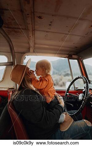 Mother and baby girl bonding in vehicle View Large Photo Image Stock Photo - Mother and baby girl bonding in vehicle. Fotosearch