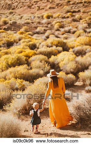 Mother and baby girl walking hand in hand, Kennedy Meadows, California, US View Large Photo Image Stock Photograph - Mother and baby girl walking hand in hand, Kennedy Meadows, California, US. Fotosearch