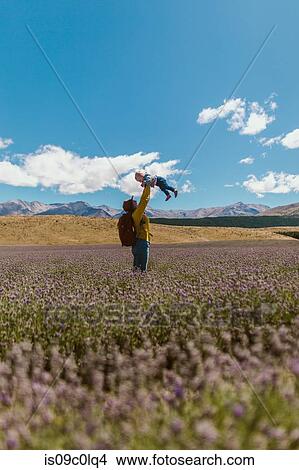 Mother and baby playing in meadow, Wanaka, Taranaki, New Zealand View Large Photo Image Picture - Mother and baby playing in meadow, Wanaka, Taranaki, New Zealand. Fotosearch