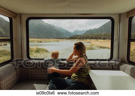 Stock Photograph - Mother and baby relaxing in motorhome, Queenstown, Canterbury, New Zealand. Fotosearch
